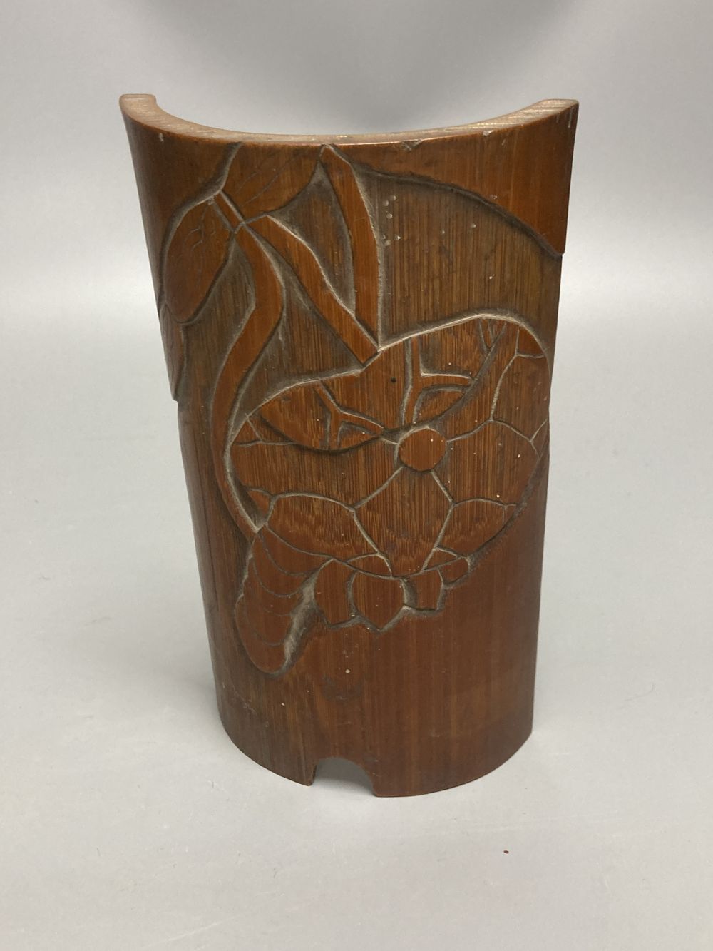 A Chinese bamboo group of figures on an ox and a wrist rest, 23 and 17cm